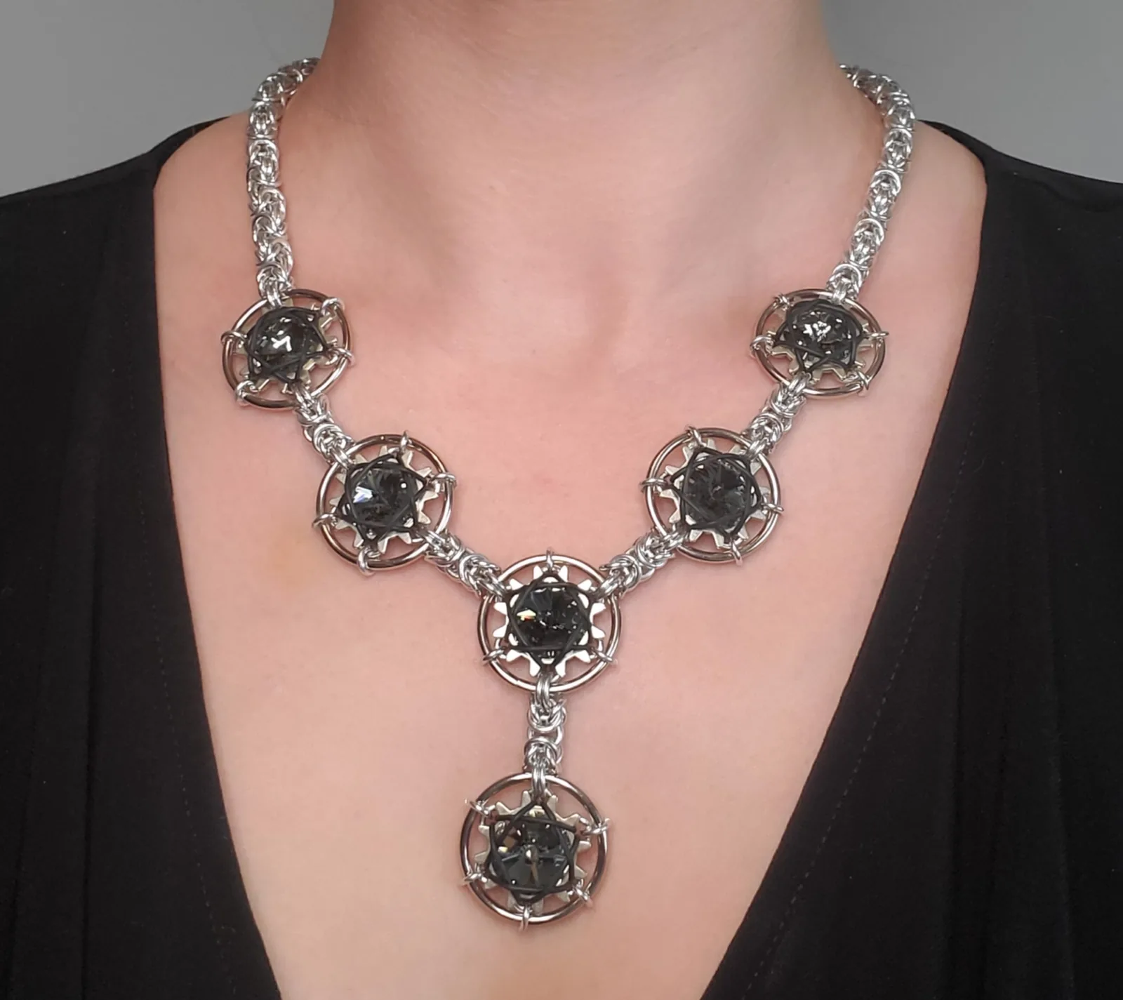 Scale necklace worn by a model