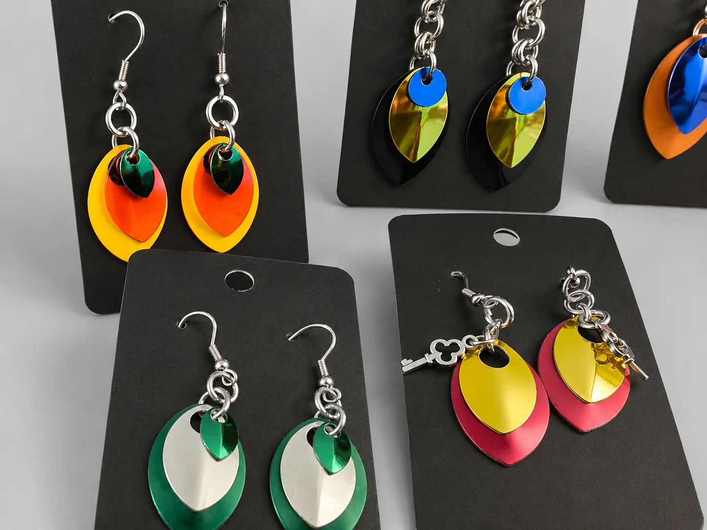 Close-up selection of colorful scale earrings