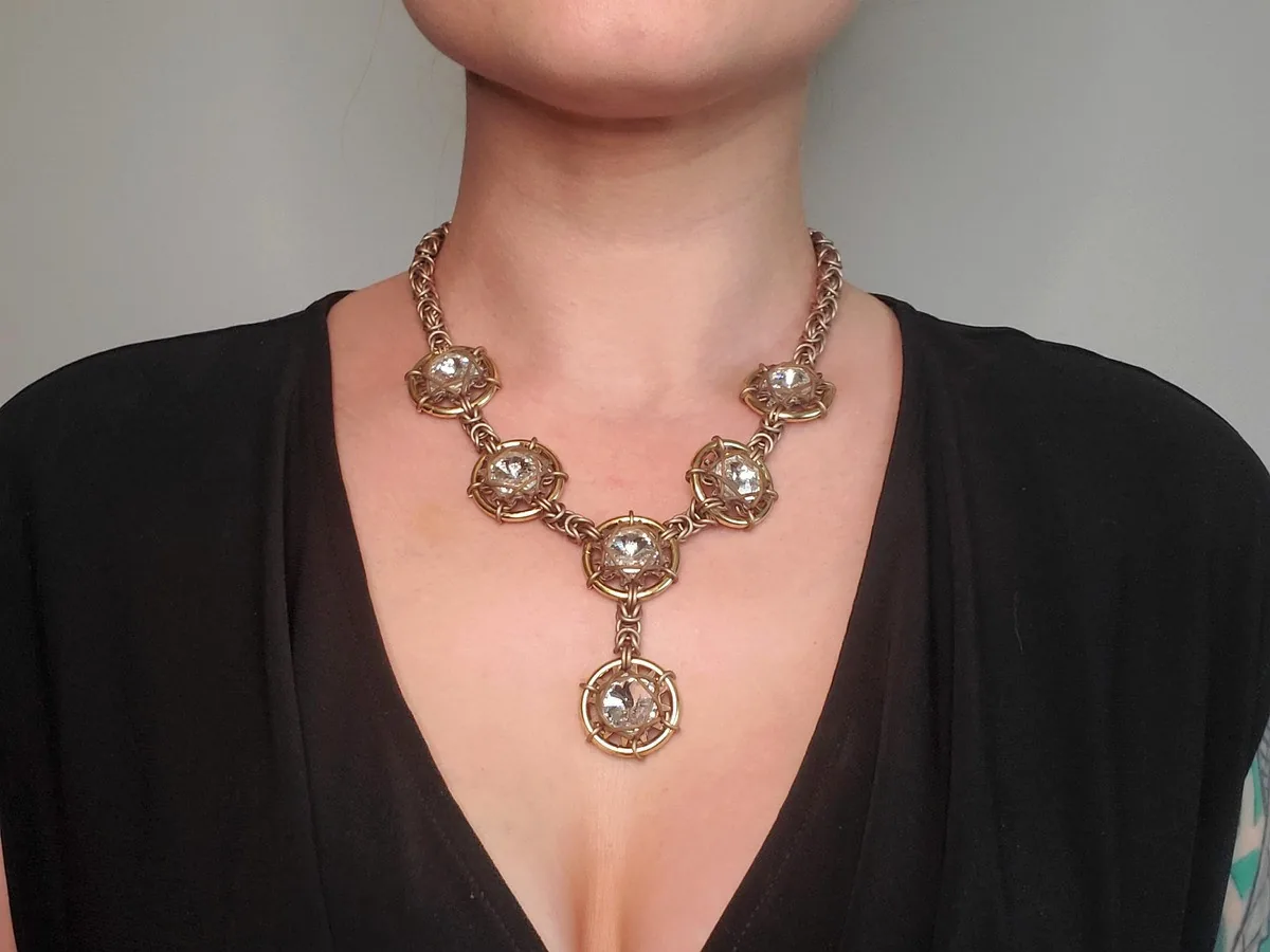 Galaxy and Stardust necklace in a warm gold-tone finish with clear faceted crystals