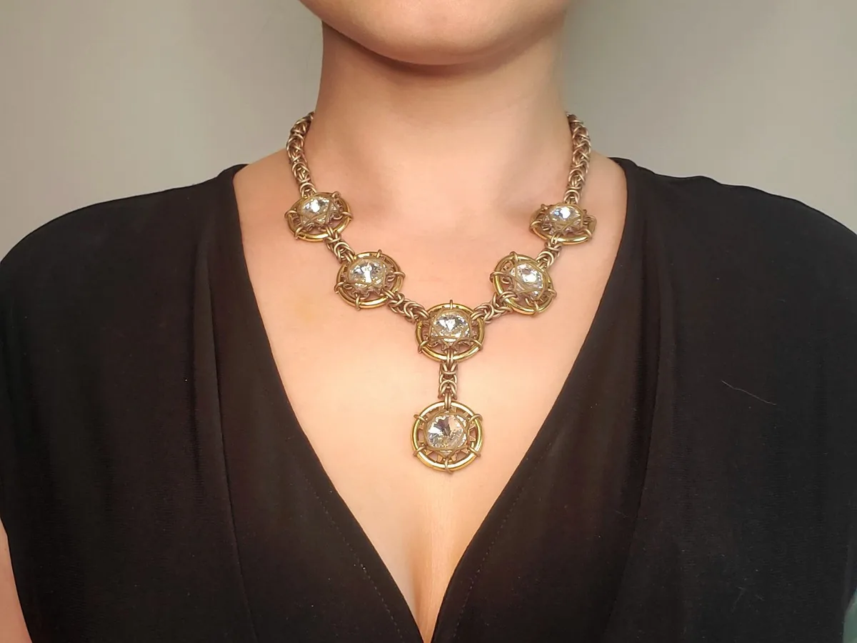 Front view of the Galaxy and Stardust necklace in a bright warm gold-tone finish