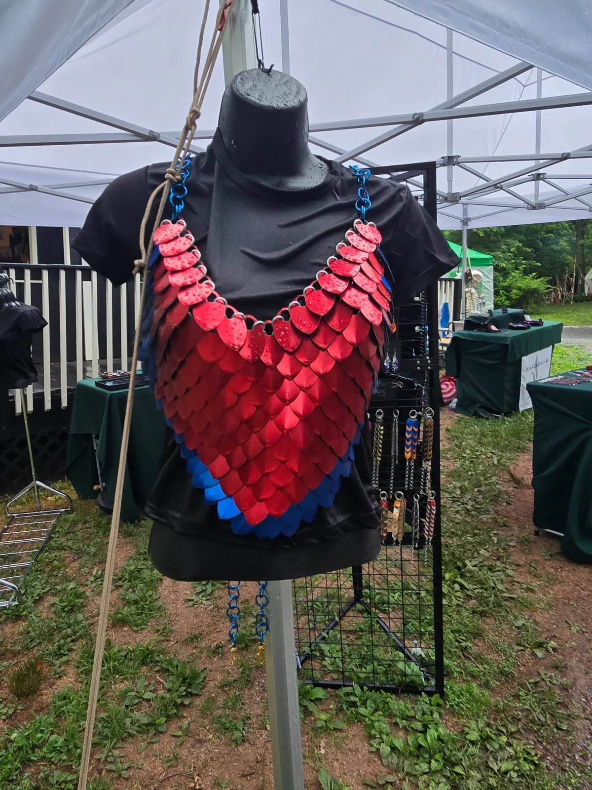 Red and blue scale top displayed on a mannequin under the tent