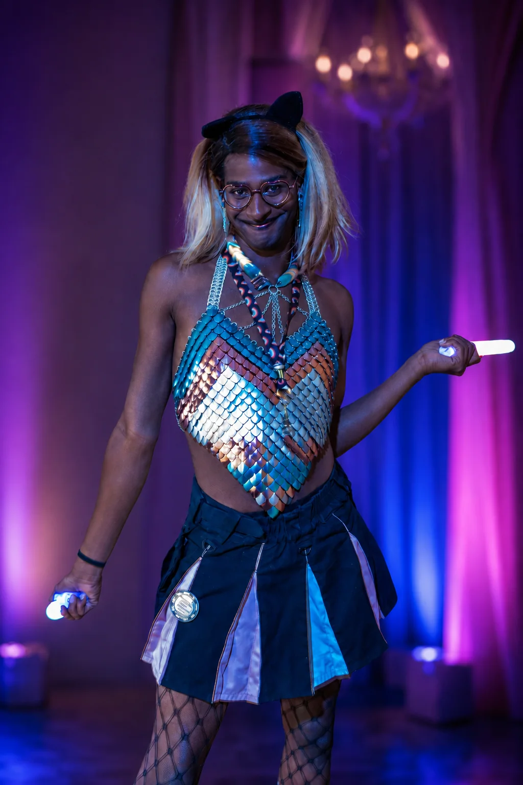Model wearing a teal and rose-gold scale top