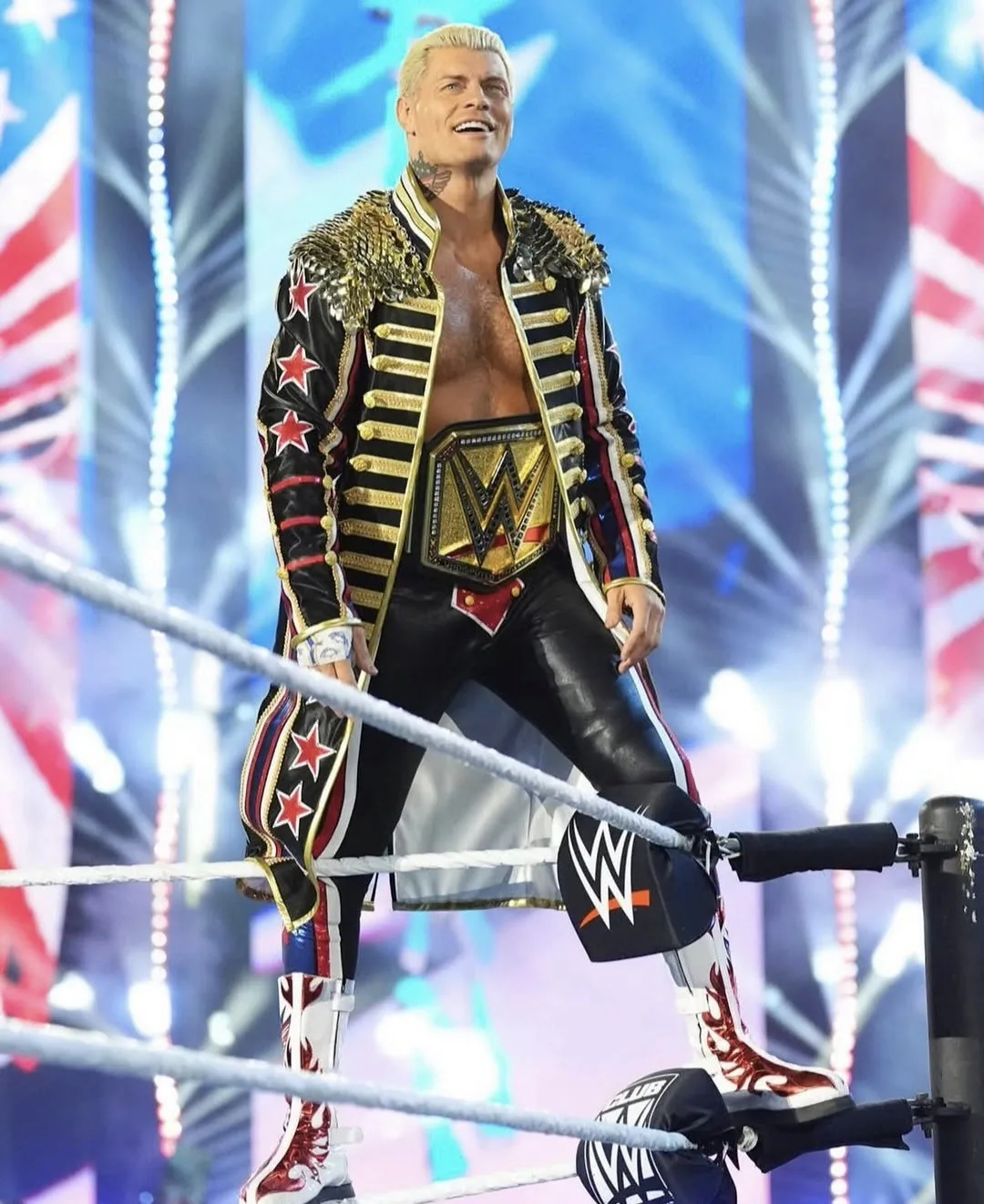 Cody Rhodes in the ring wearing an entrance coat with gold scale shoulder detailing