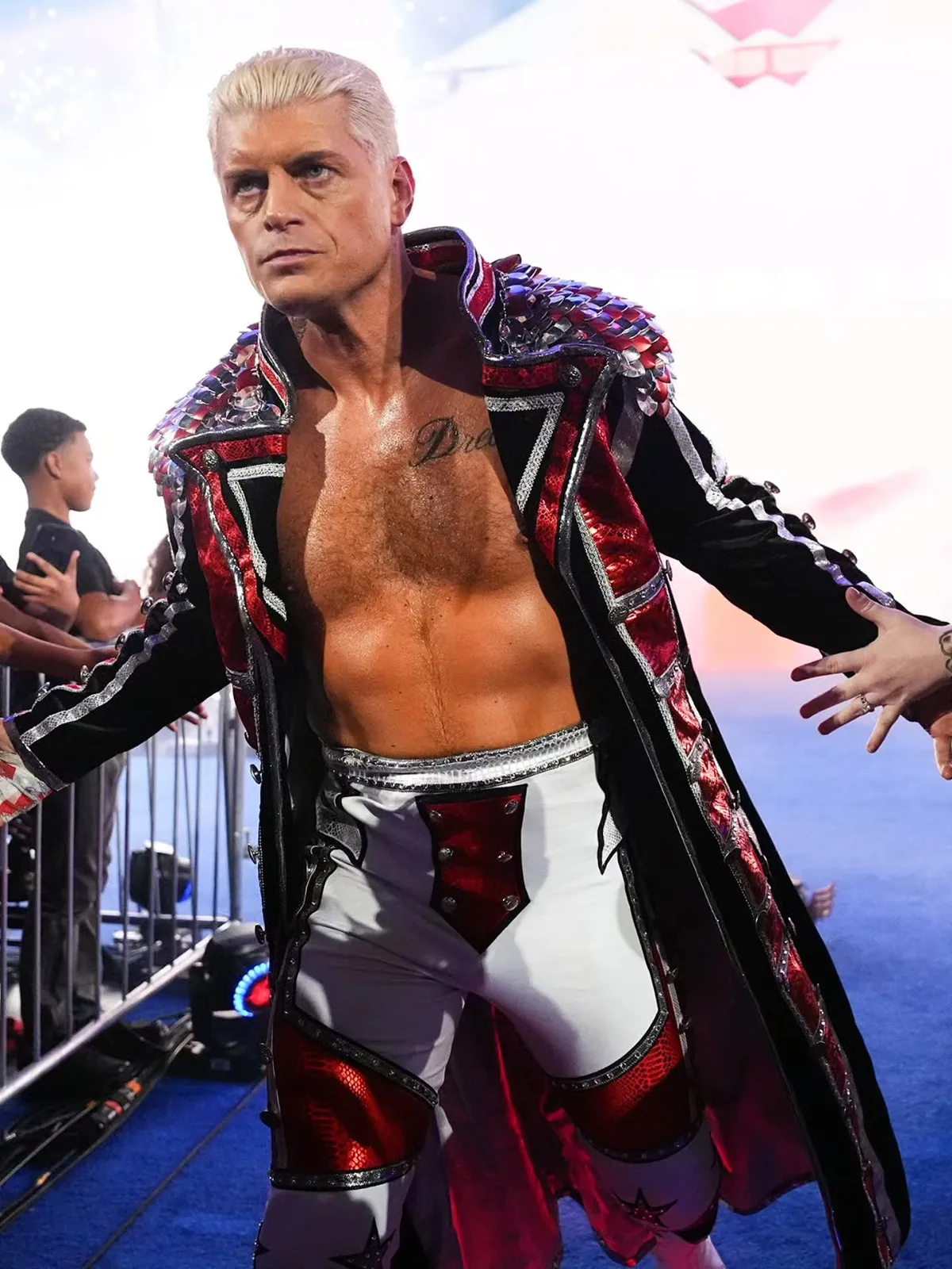 Front view of Cody Rhodes wearing the red, black, and silver entrance coat with scale shoulder detailing
